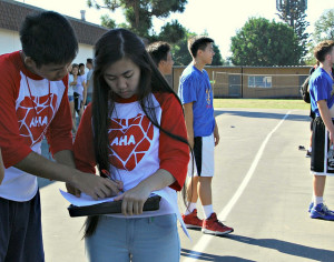 Johnny Nguyen ('17) and Emily Tran ('17) discussing which courts each time should play in. Photo by Elise Tran