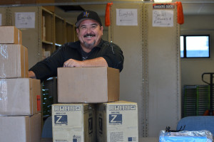Blais unpacks boxes of books. Photo by Jamie Pham.