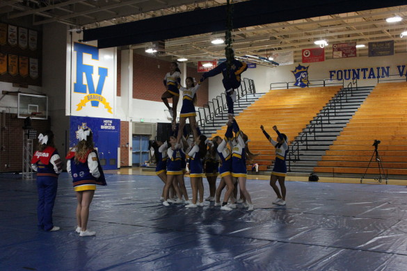 Cheer rehearses their formation to perfect all mistakes before the assembly. Photo by Ivy Duong